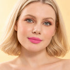 Model wearing Oplenza Signature Longwear Matte Lipstick in 01 Tulle, showing nude pink matte lips.