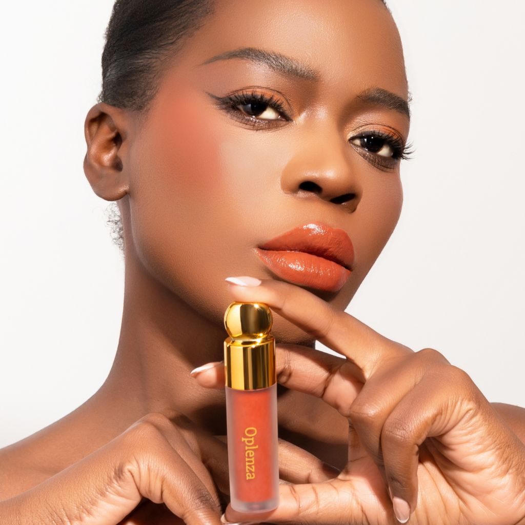 Woman wearing and presenting oplenza Velvet Whip cream blush in shade Apricot Melt