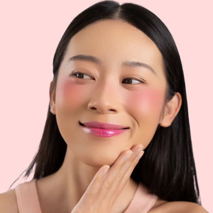 Woman wearing and showcasing the effect of oplenza Velvet Whip cream blush in shade Bloom Rush