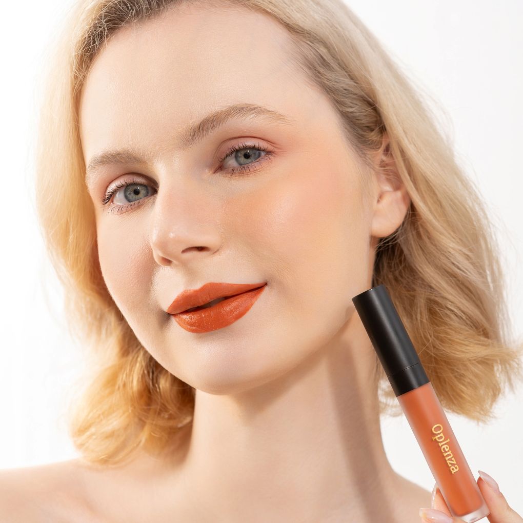 Woman wearing and showcasing the elegant Oplenza Signature Velvet Liquid Lipstick in the color Burnished Rose.