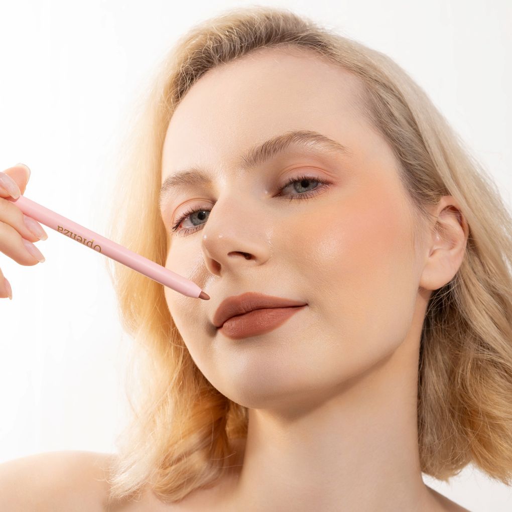An elegant woman wearing and showcasing the vegan, luxury and cruelty free oplenza Define & Refine Lip Liner in the color Clay Rose