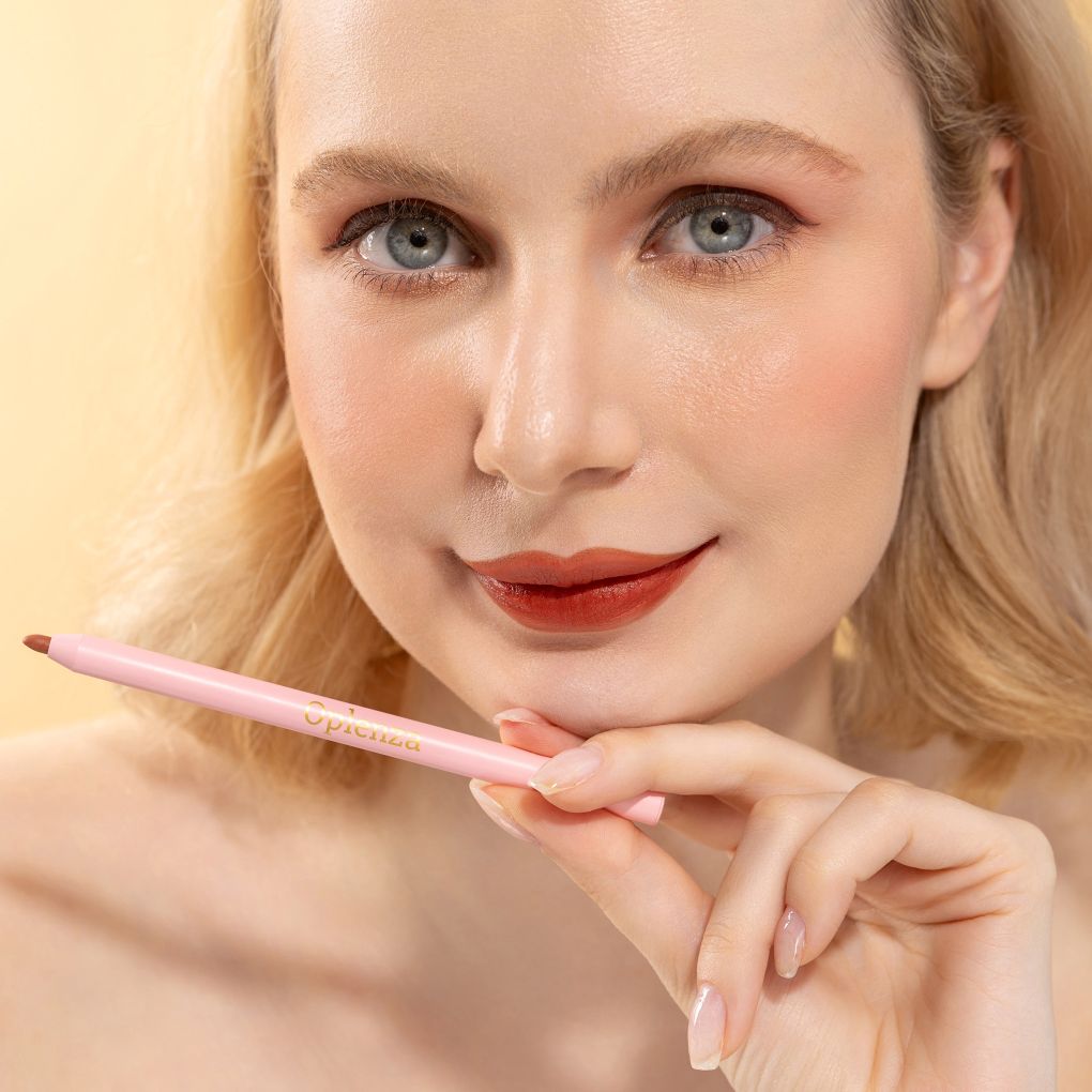 An elegant woman wearing and showcasing the vegan, luxury and cruelty free oplenza Define & Refine Lip Liner in the color 13 Cocoa Rouge