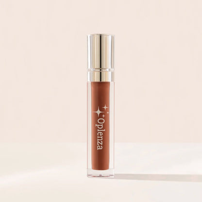 Lip gloss with golden cap and 'Oplenza' branding on a beige background. Cruelty free makeup