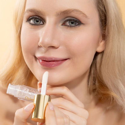A woman wearing and showcasing the best cruelty-free, vegan, shiny and hydrating lip gloss in shade Diamond Milk
