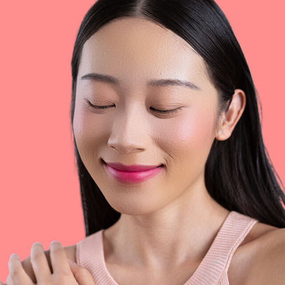 Woman wearing and showcasing the effects of the best cruelty-free Oplenza Signature Matte Lipstick in shade Joyful