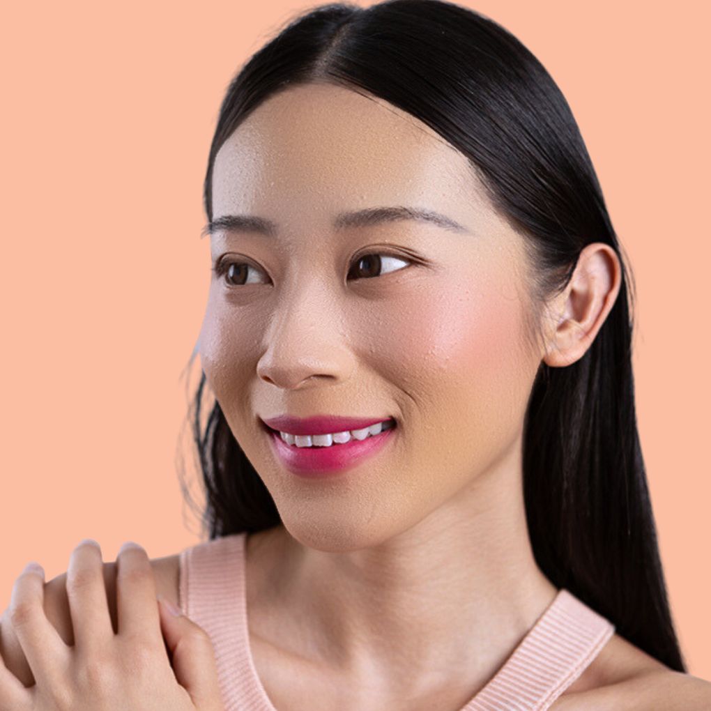 Woman wearing and showcasing the effects of the best cruelty-free Oplenza Signature Matte Lipstick in shade Joyful