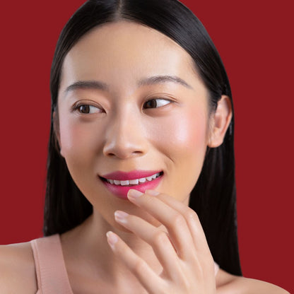 Woman wearing and showcasing the effects of the best cruelty-free vegan Oplenza Signature Matte Lipstick in shade Joyful