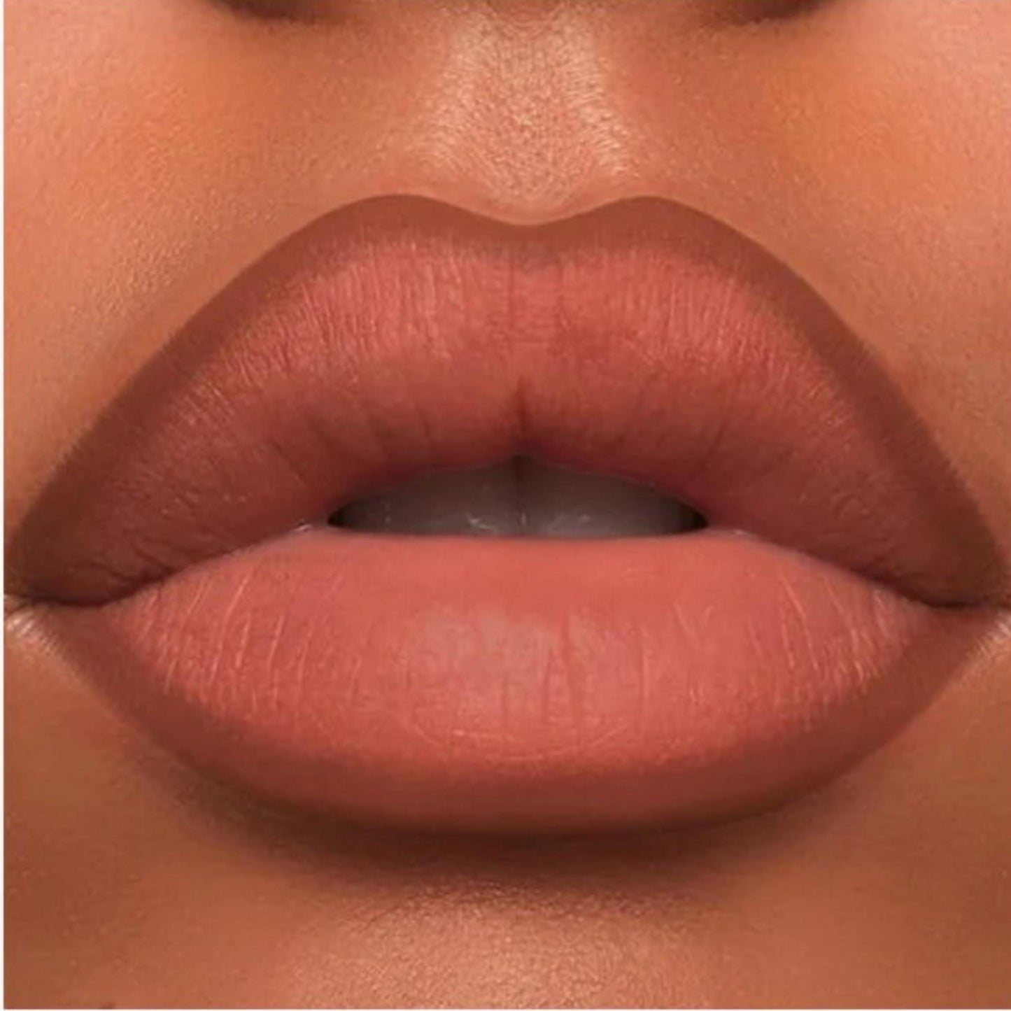 A close-up of the Oplenza Velvet Whisper Lip Liner effect on a woman's lips in the shade Cacao Truffle