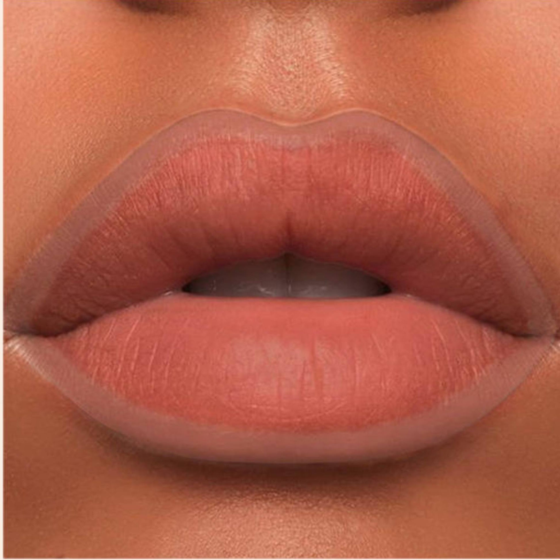 A close-up of the Oplenza Velvet Whisper Lip Liner effect on a woman's lips in the shade Desert Mirage