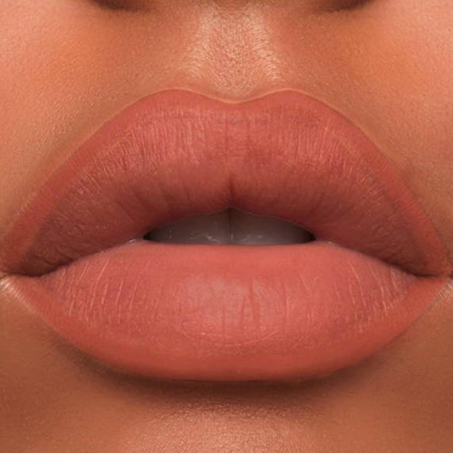 A close-up of the Oplenza Velvet Whisper Lip Liner effect on a woman's lips in the shade Spiced Terracotta