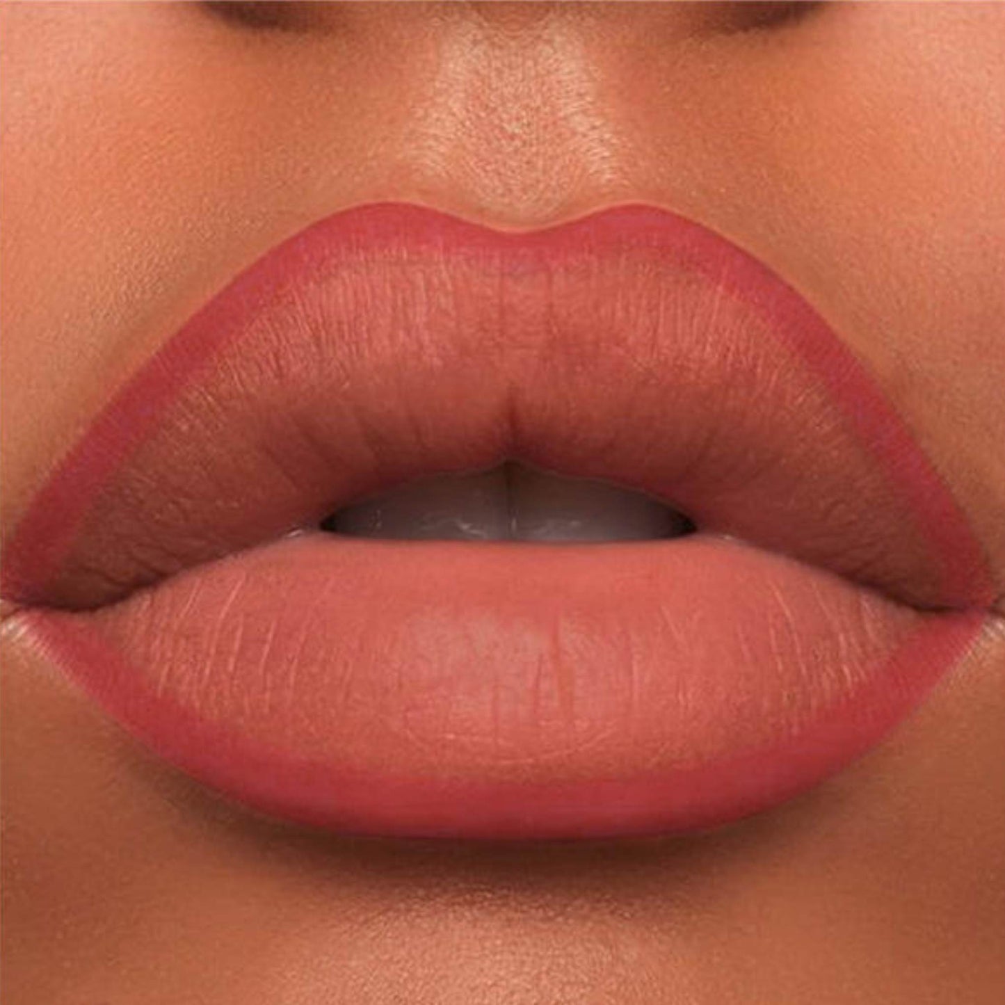 A close-up of the Oplenza Velvet Whisper Lip Liner effect on a woman's lips in the shade Sunset Amber