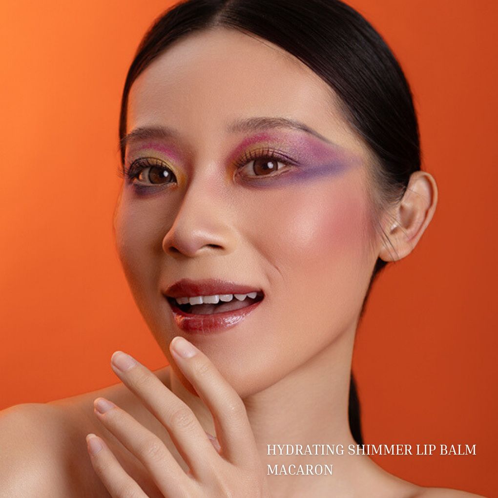 Model wearing Oplenza Hydrating Shimmer Lip Balm in Macaron with luminous shimmer finish