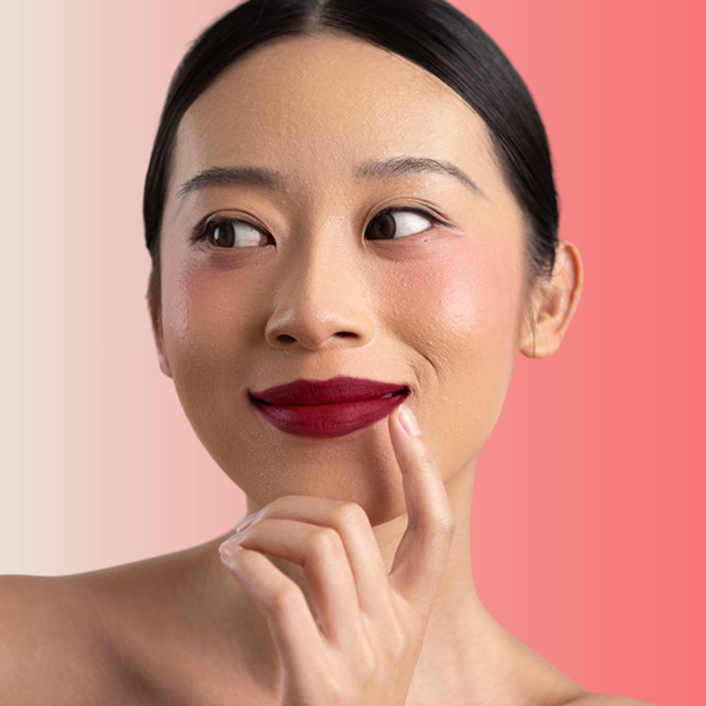 An elegant woman wearing and showcasing the vegan, luxury and cruelty free oplenza Define & Refine Lip Liner in the color  Merlot Stain