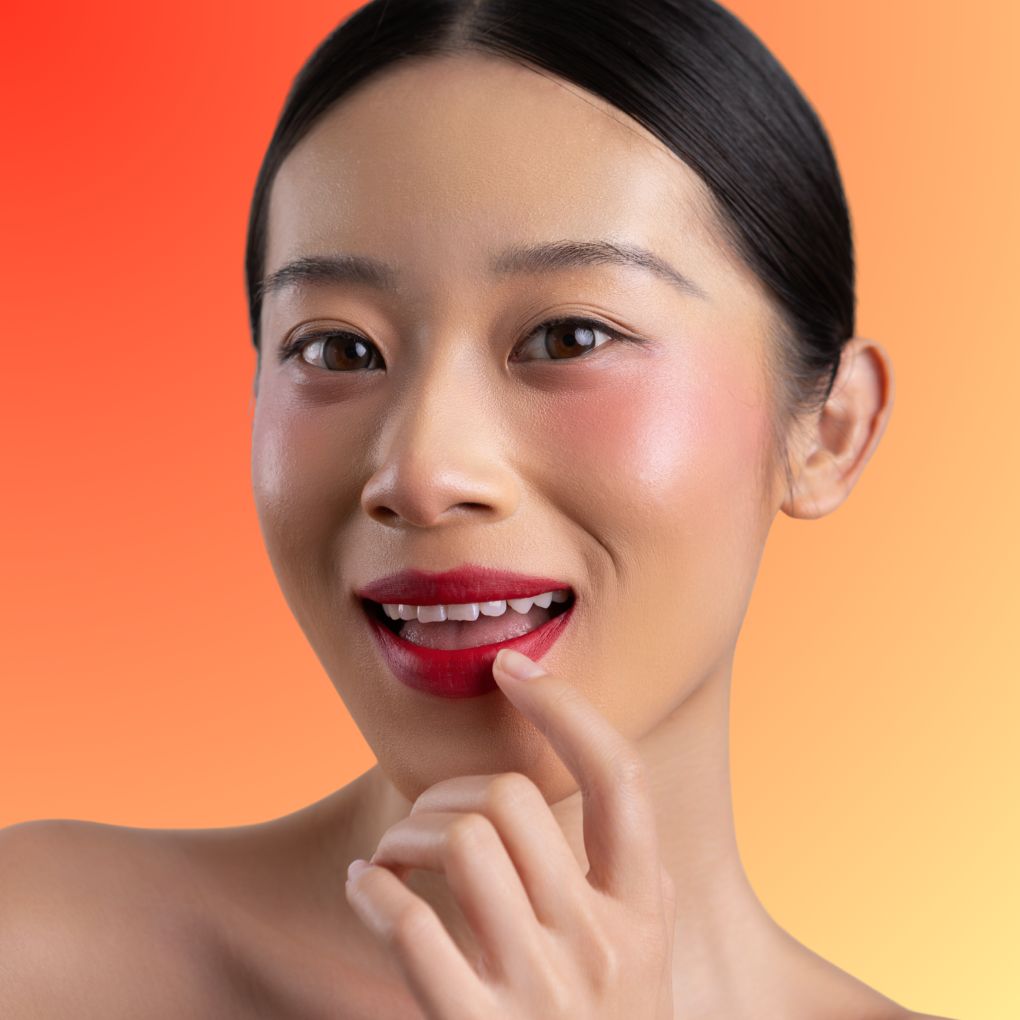 Woman wearing and showcasing the effects of the best cruelty-free Oplenza Signature Matte Lipstick in shade Passionate