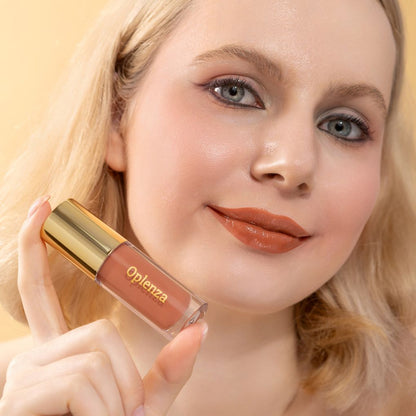 A woman wearing and showcasing the best cruelty-free, vegan, shiny and hydrating lip gloss in shade Peach Nectar