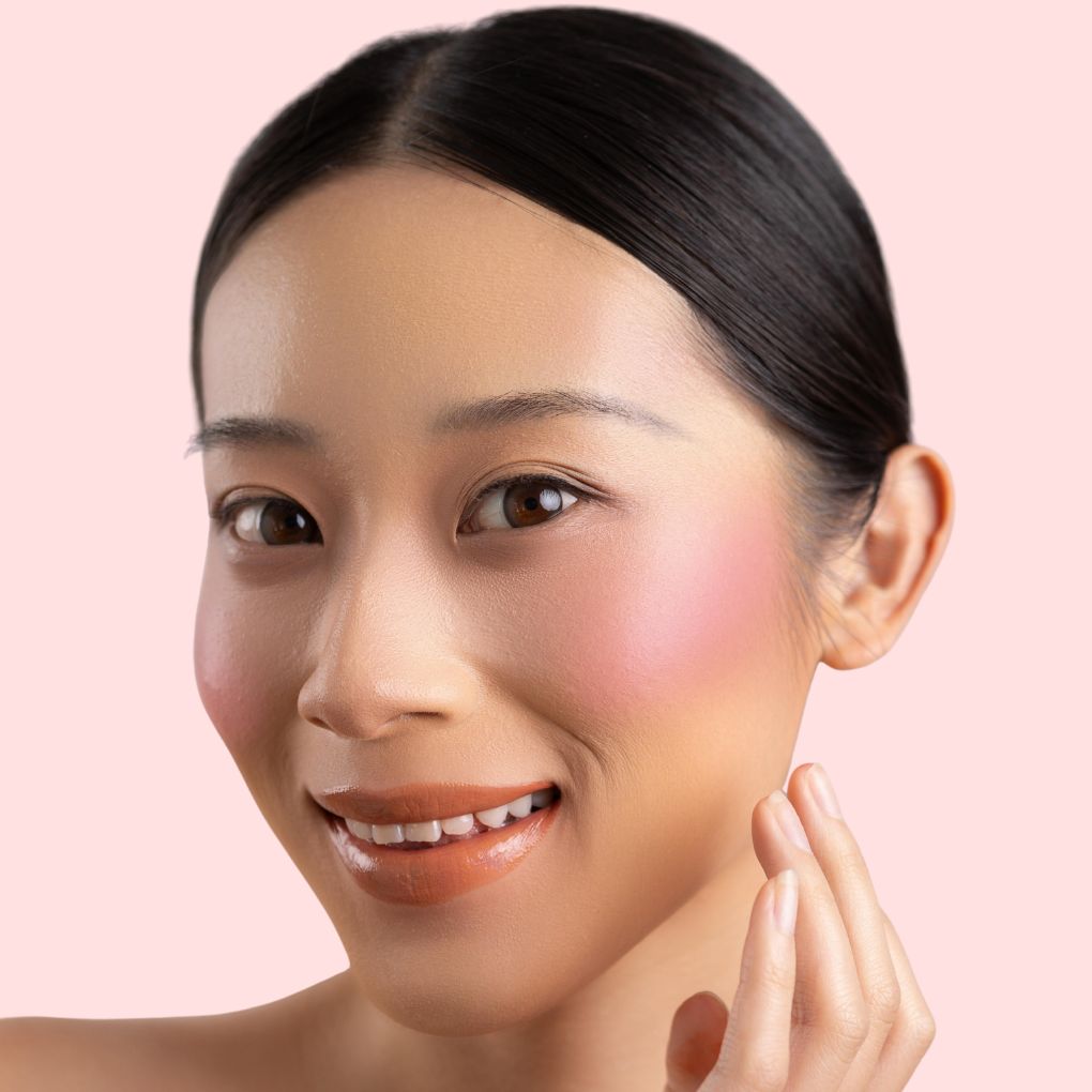 Woman wearing and showcasing the effect of oplenza Velvet Whip cream blush in shade Petal Milk