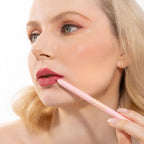 An elegant woman wearing and showcasing the vegan, luxury and cruelty free oplenza Define & Refine Lip Liner in the color 14 Rosy Dusk