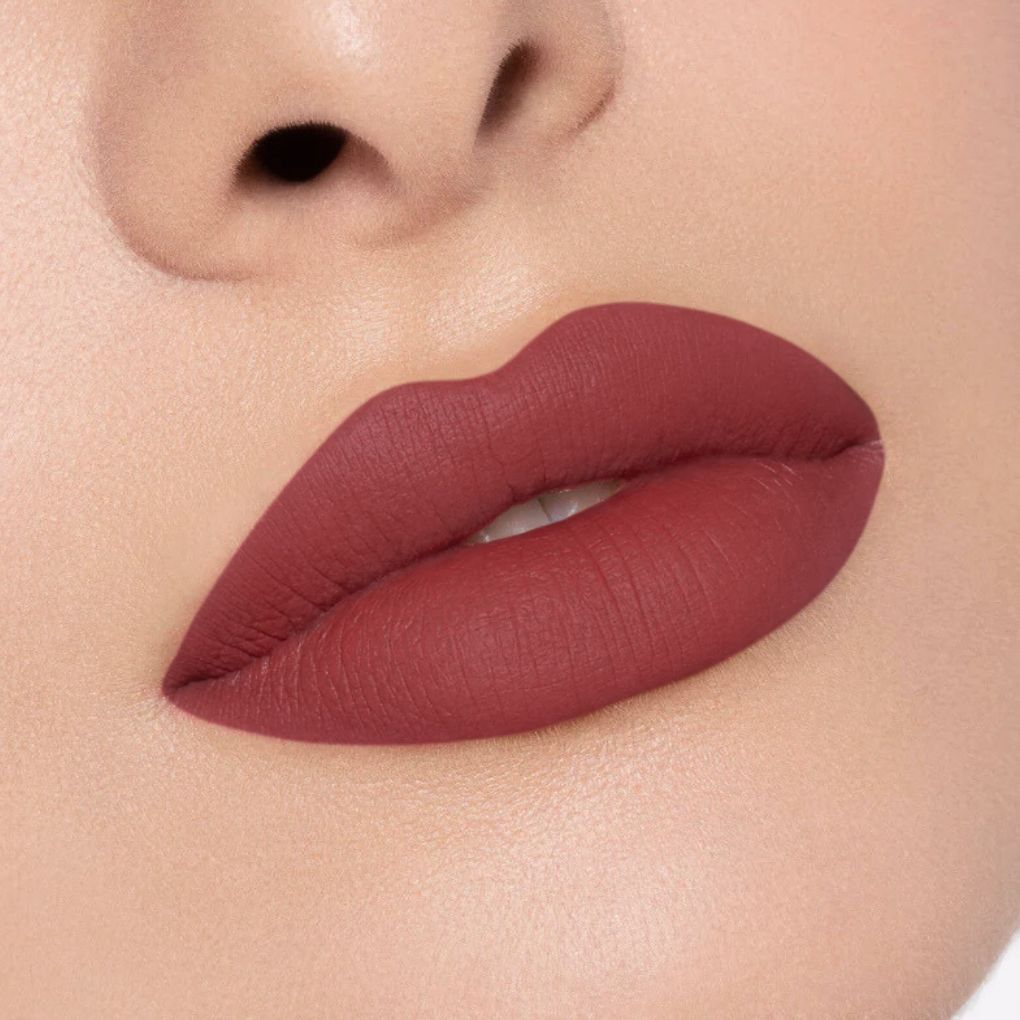 Close-up of a creamy, comfortable matte lipstick applied on lips in shade 03 No Compromise