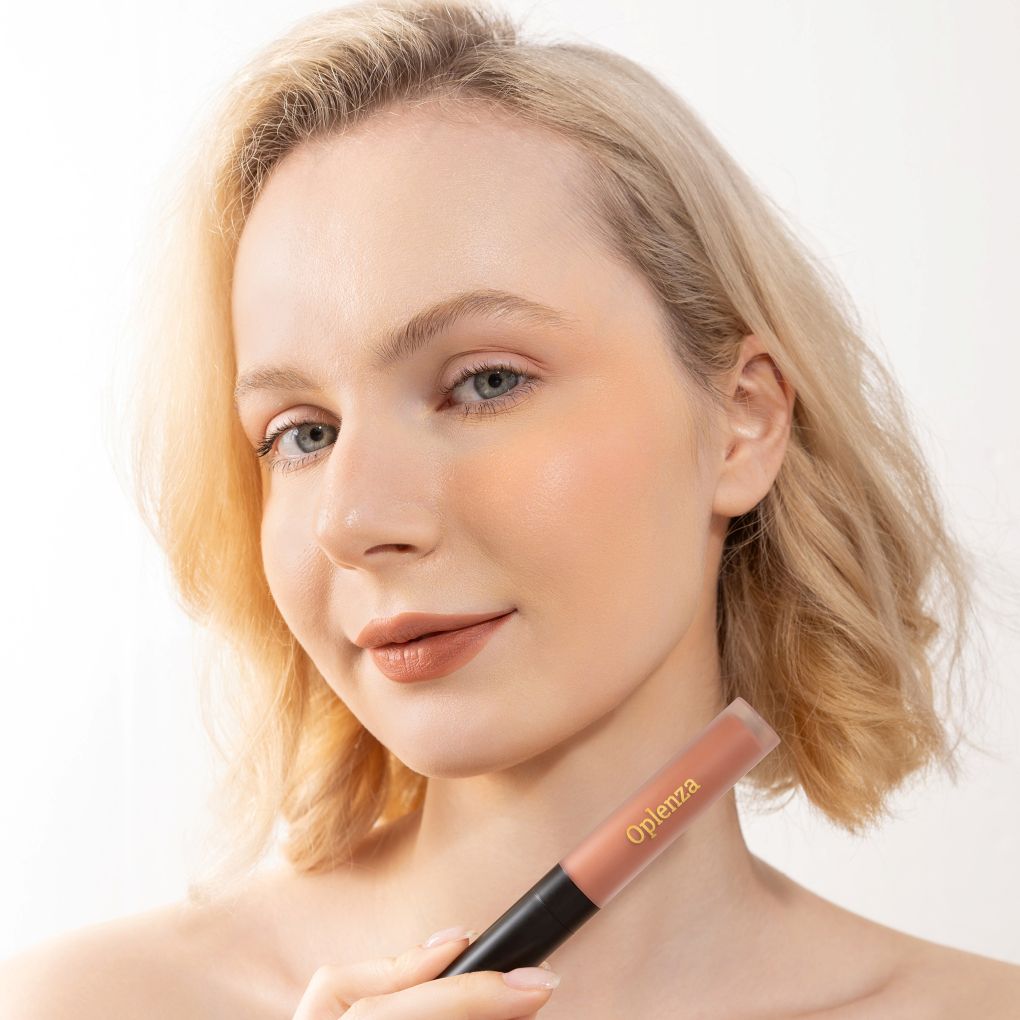 A Woman wearing and showcasing the elegant Oplenza Signature Velvet Liquid Lipstick in the color Silken Clay