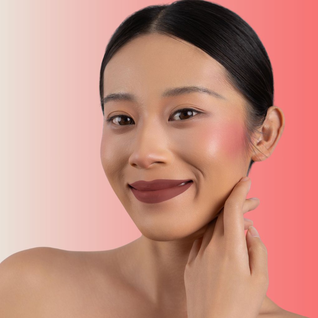 An elegant woman wearing and showcasing the vegan, luxury and cruelty free oplenza Define & Refine Lip Liner in the color 07 Spiced Chestnut