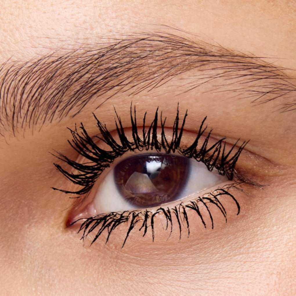 Close-up of an eye wearing and showcasing the effect of oplenza mascara on the eyelashes.
