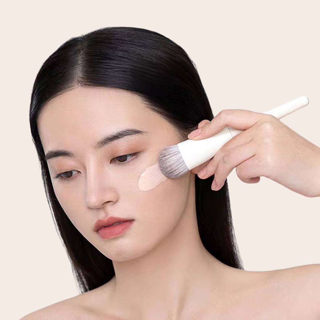 Woman using and showcasing Oplenza contouring brush.
